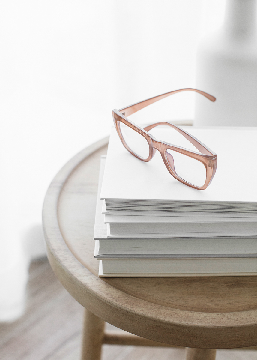 Evolvere Psychology - Los Angeles Therapy: Glasses on a stack of books signifying a good reader